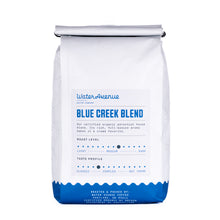 Load image into Gallery viewer, White coffee bag with blue text and design on a white background